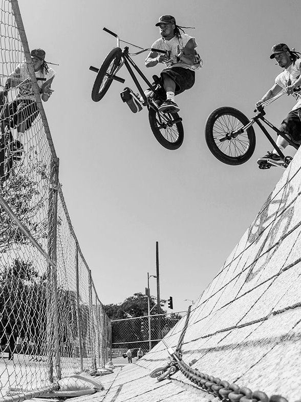 BMX rider in the air over a wall
