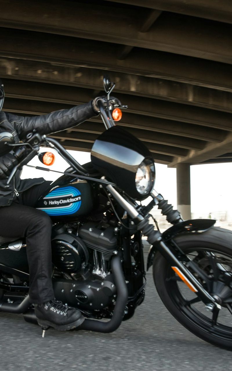 Rider on a Harley-Davidson motorcycle under a bridge