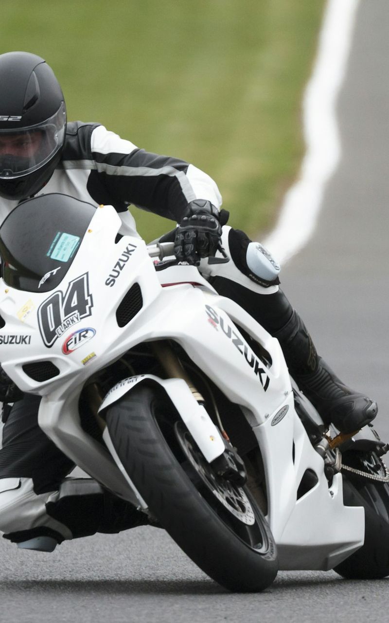 Street bike motorcycle rider leaning into a turn